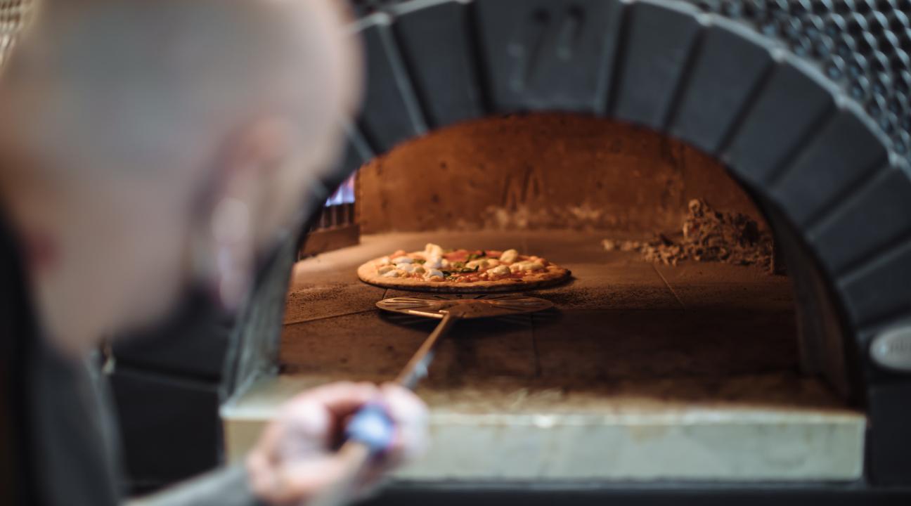 pizza coming out of the oven