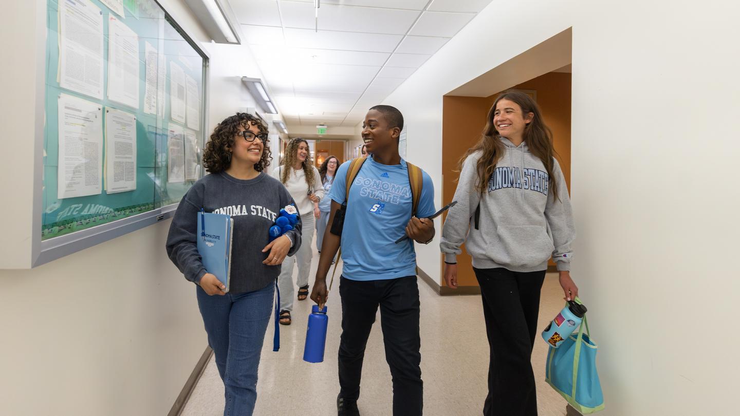 3 students walking to class at darwin hall